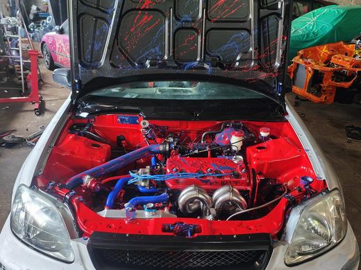 Civic EK blanche en cours de restauration dans l'atelier, capot ouvert